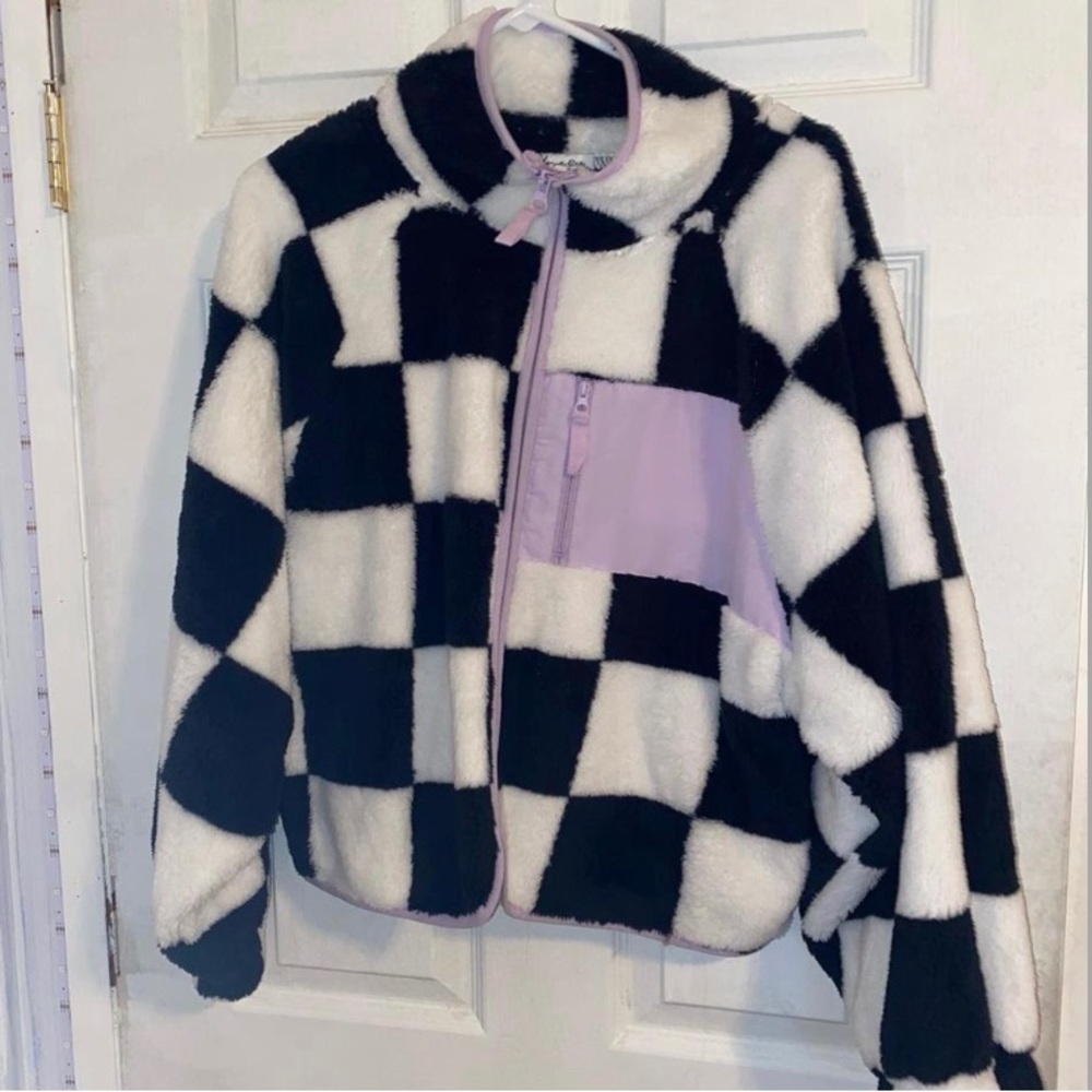 Black and white kids jacket size large has purple zipper and front piece, worn 2